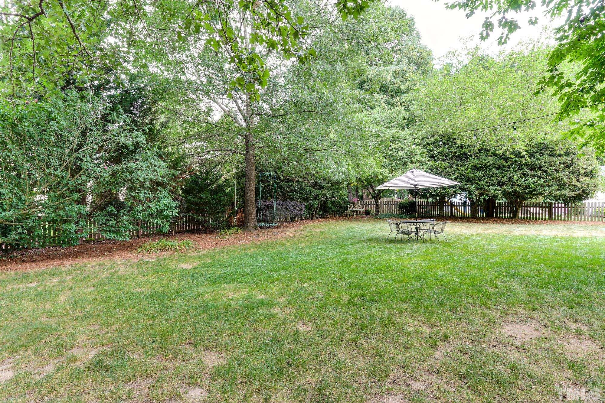 8913 Lindenshire Road Raleigh, NC 27615 - Photo 27 of 27 a view of backyard with a garden and trees