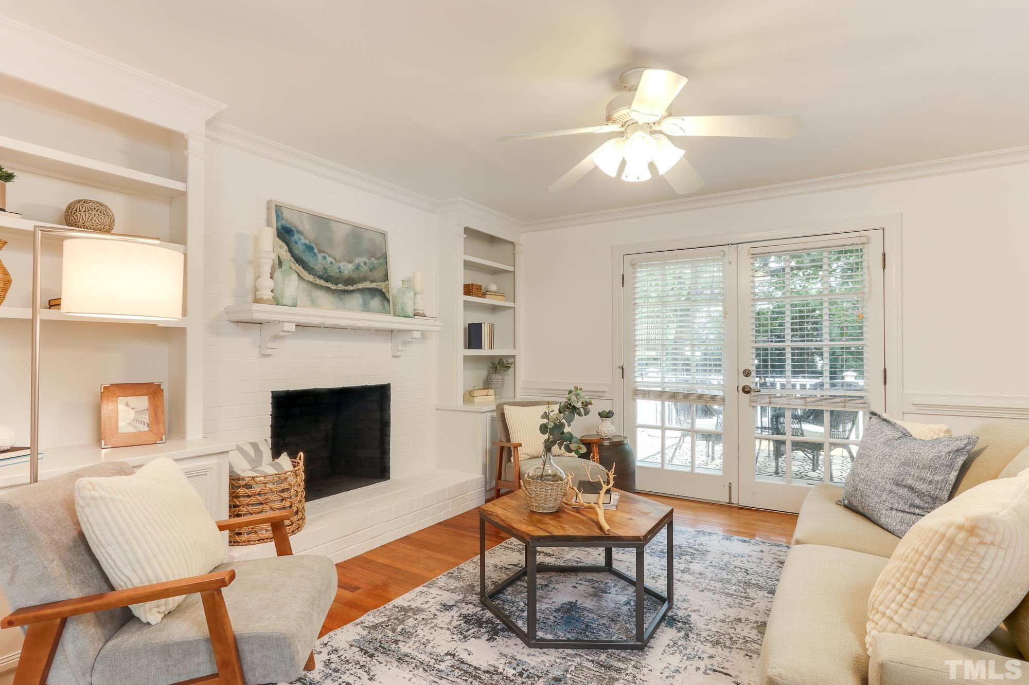 8913 Lindenshire Road Raleigh, NC 27615 - Photo 9 of 27 a living room with furniture and a fireplace