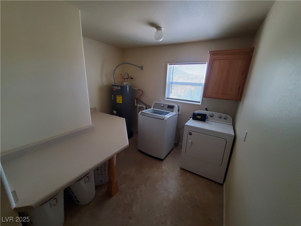 5272 Truman Lane Caliente, NV 89008 - Photo 15 of 39 Laundry room featuring electric water heater, washer and dryer, and cabinet space