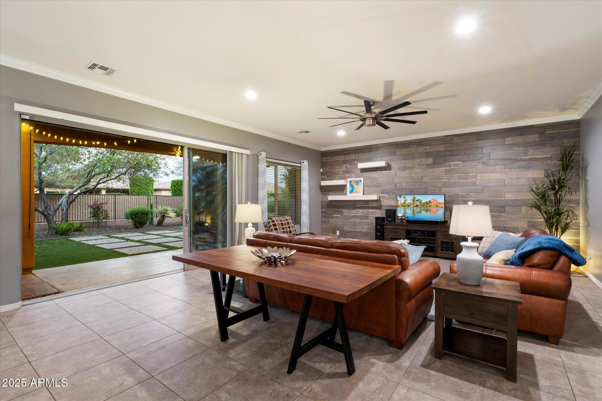 5123 South Mariposa Drive Gilbert, AZ 85298 - Photo 9 of 35 a living room with furniture a fireplace and a floor to ceiling window