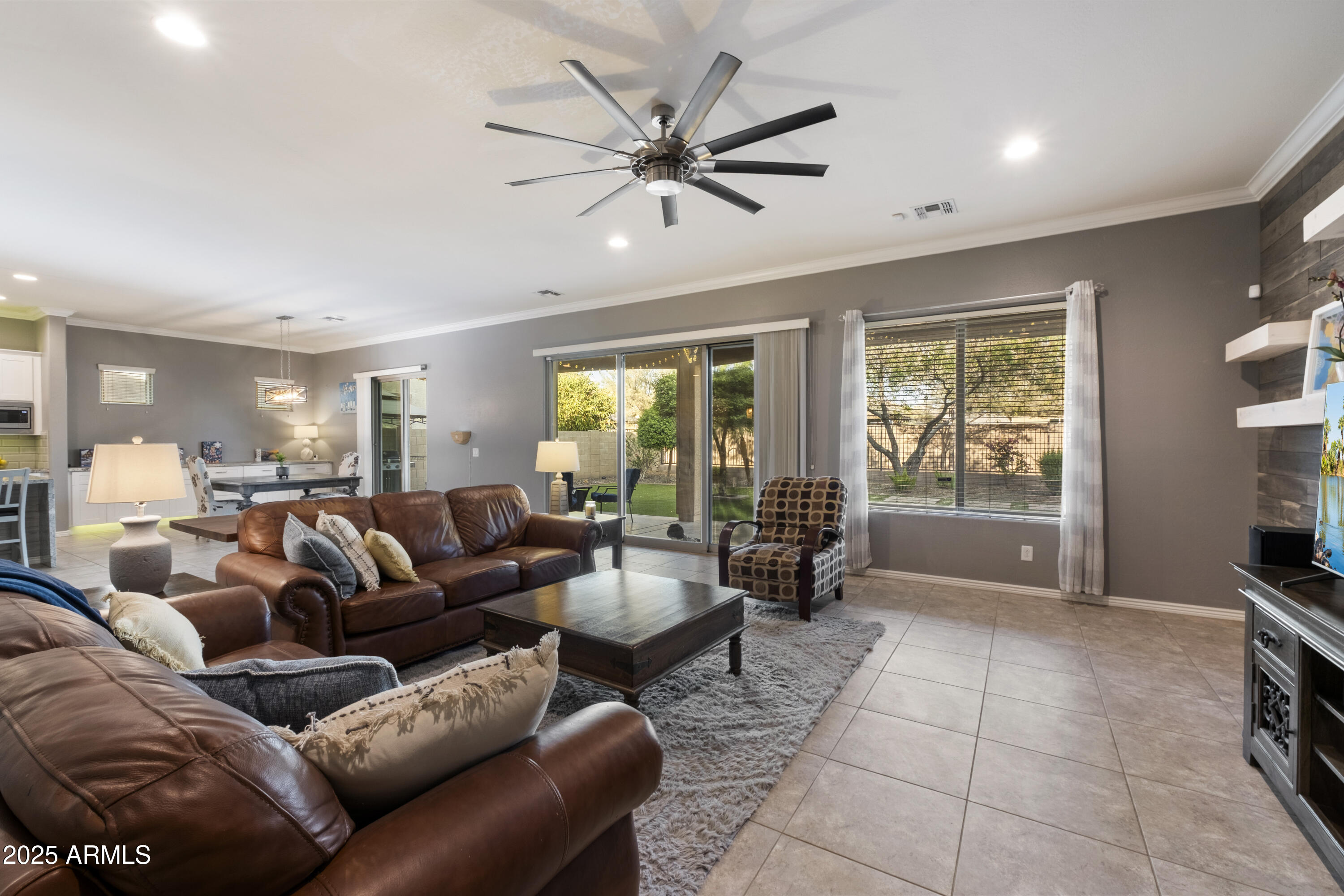 5123 South Mariposa Drive Gilbert, AZ 85298 - Photo 10 of 35 a living room with furniture and a large window with kitchen view