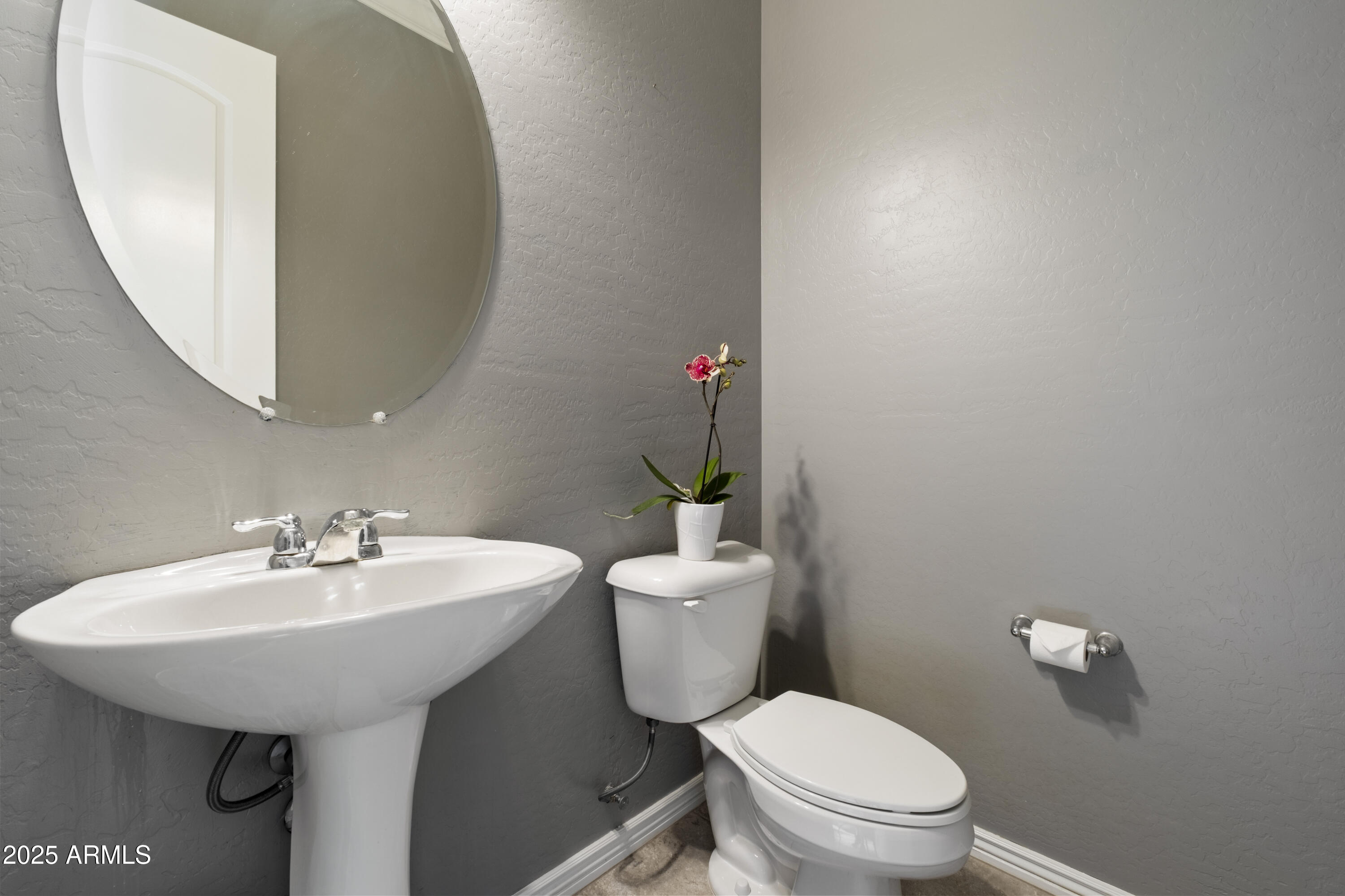 5123 South Mariposa Drive Gilbert, AZ 85298 - Photo 12 of 35 a bathroom with a sink a toilet and mirror
