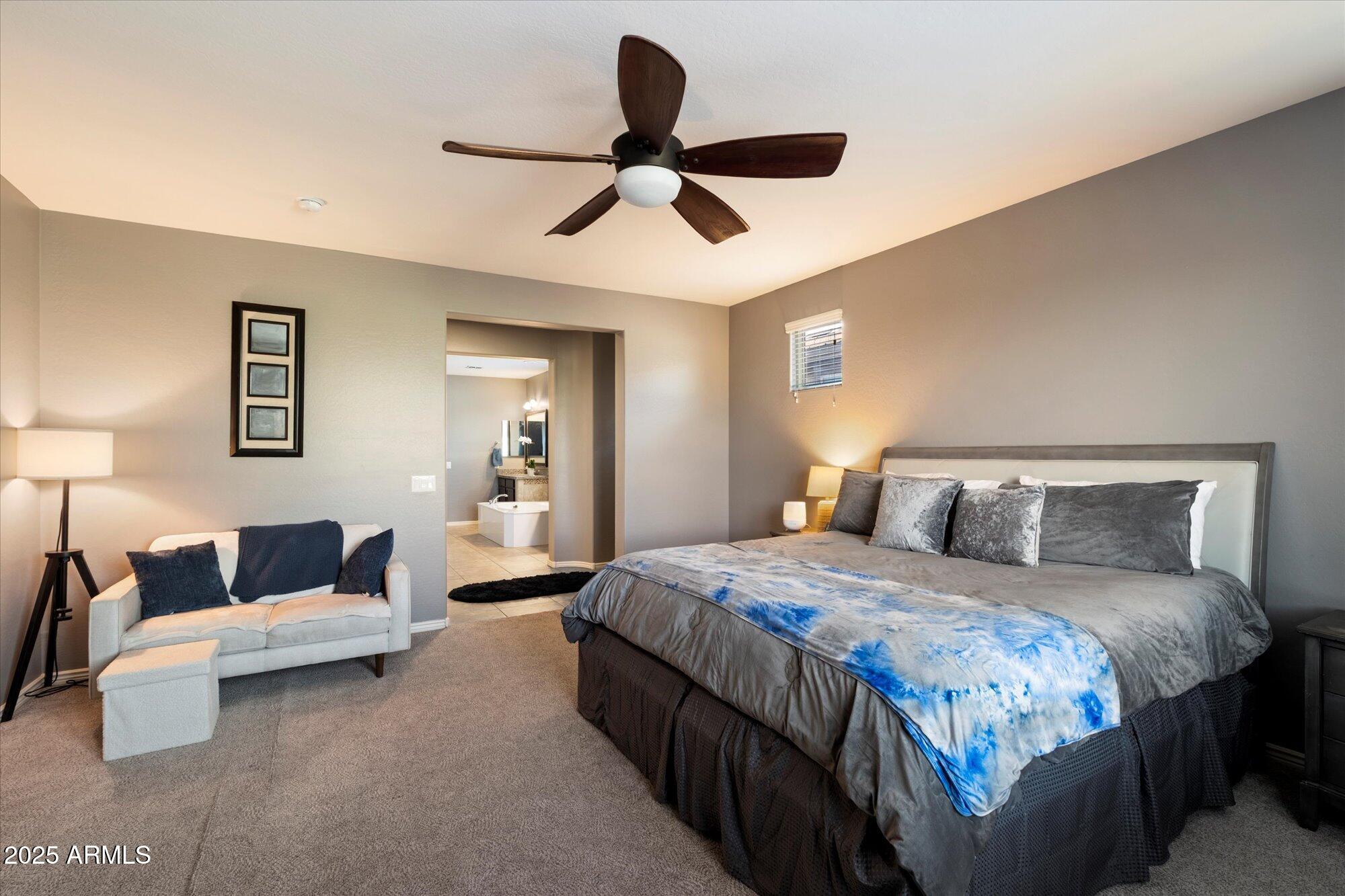 5123 South Mariposa Drive Gilbert, AZ 85298 - Photo 14 of 35 a bedroom with bed and a chandelier