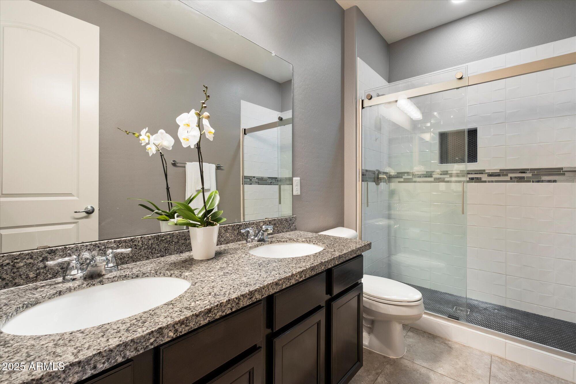 5123 South Mariposa Drive Gilbert, AZ 85298 - Photo 18 of 35 a bathroom with a granite countertop sink a toilet and shower