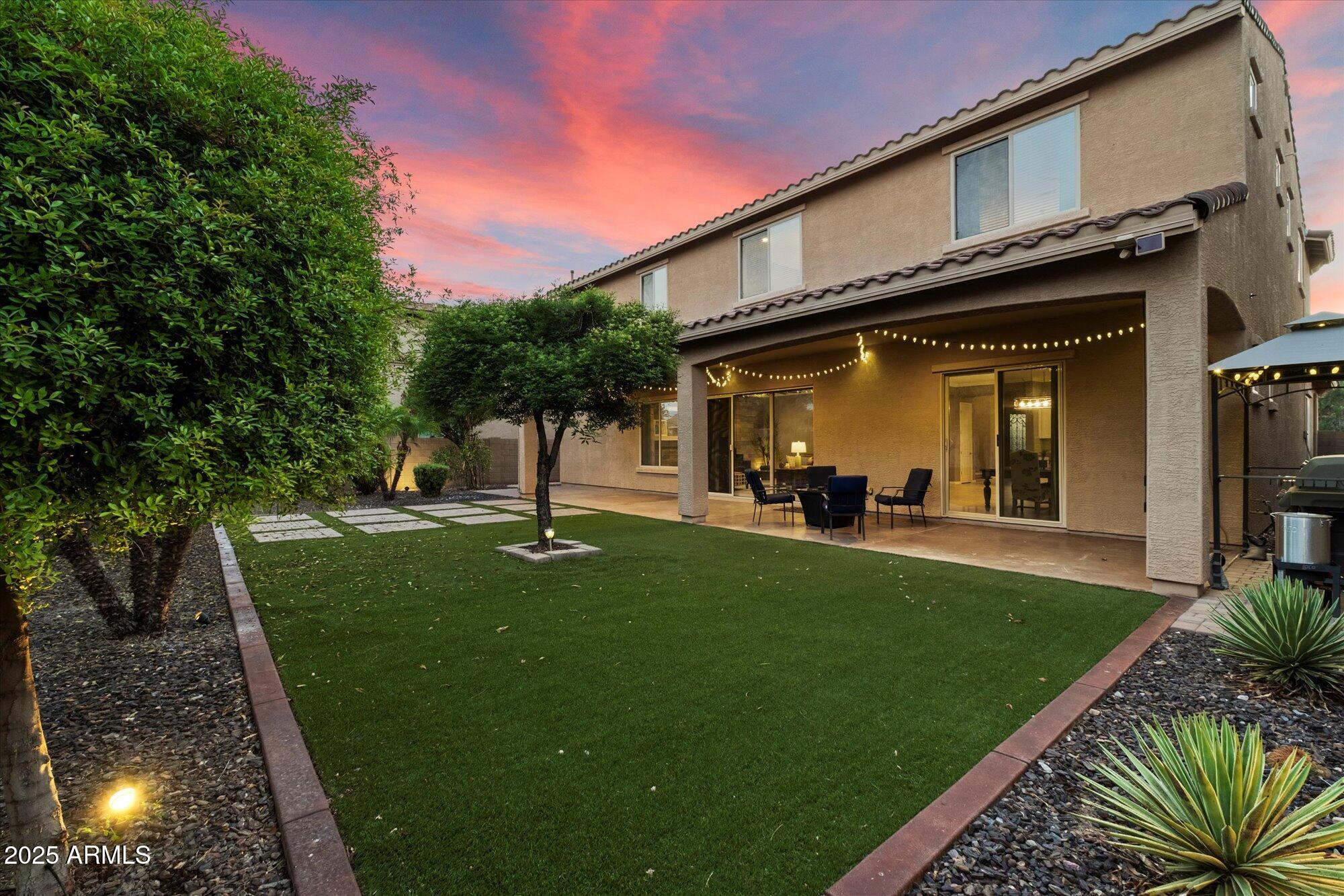 5123 South Mariposa Drive Gilbert, AZ 85298 - Photo 27 of 35 a view of a house with a swimming pool and a yard