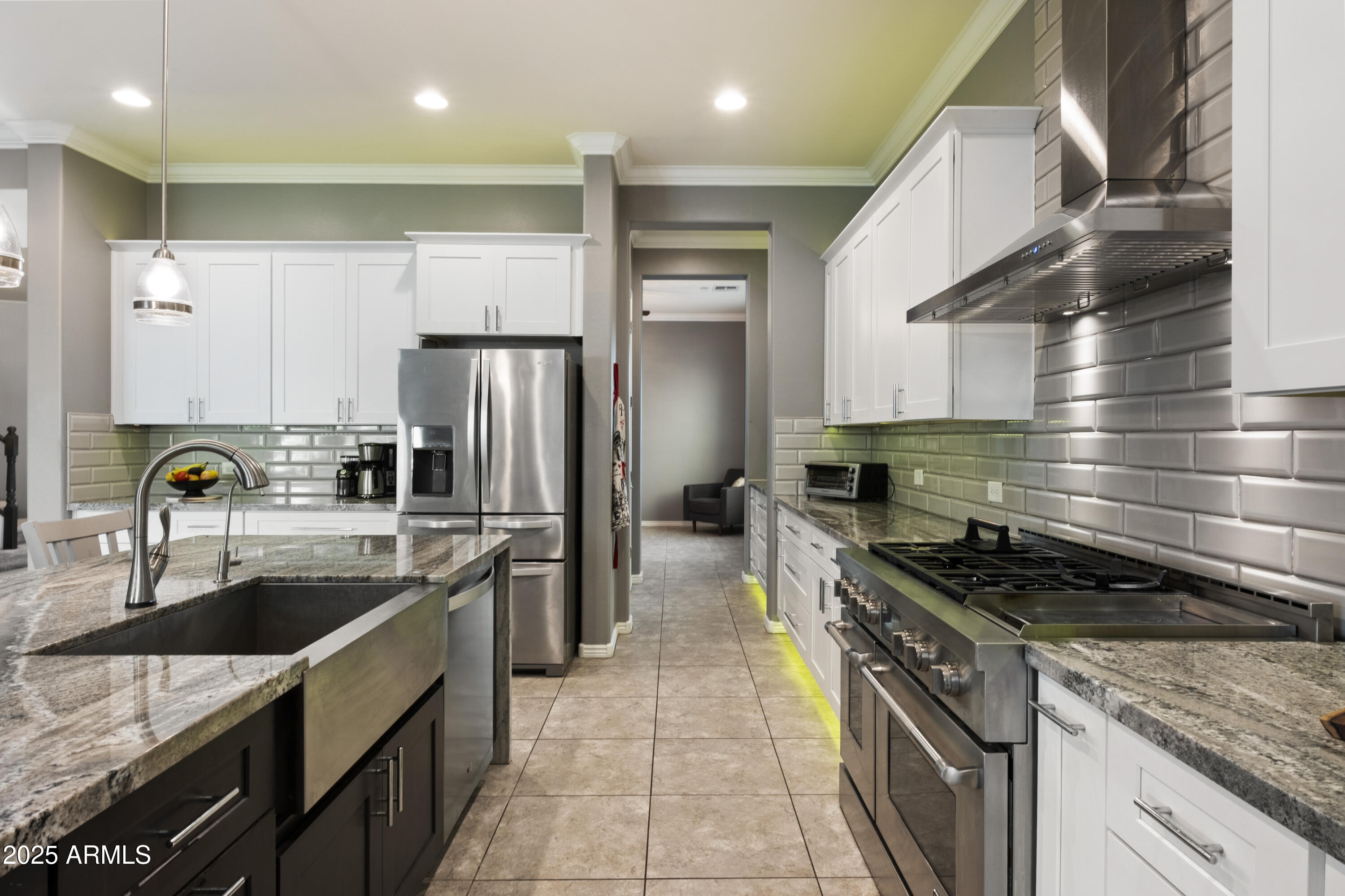 5123 South Mariposa Drive Gilbert, AZ 85298 - Photo 5 of 35 a kitchen with kitchen island stainless steel appliances a sink a stove and a refrigerator