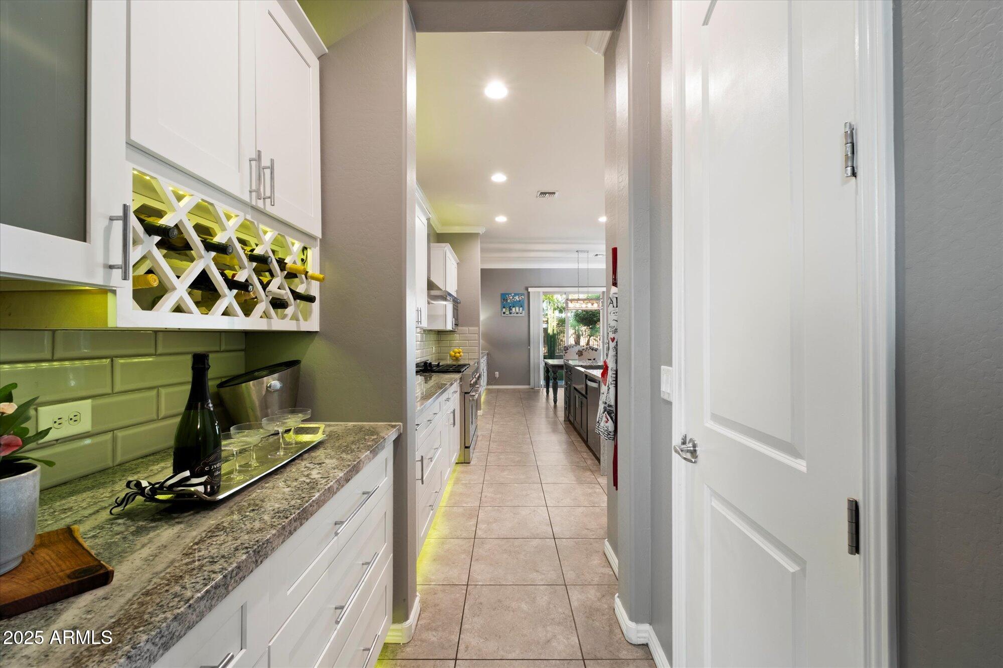 5123 South Mariposa Drive Gilbert, AZ 85298 - Photo 8 of 35 a kitchen with stainless steel appliances granite countertop a sink and a refrigerator