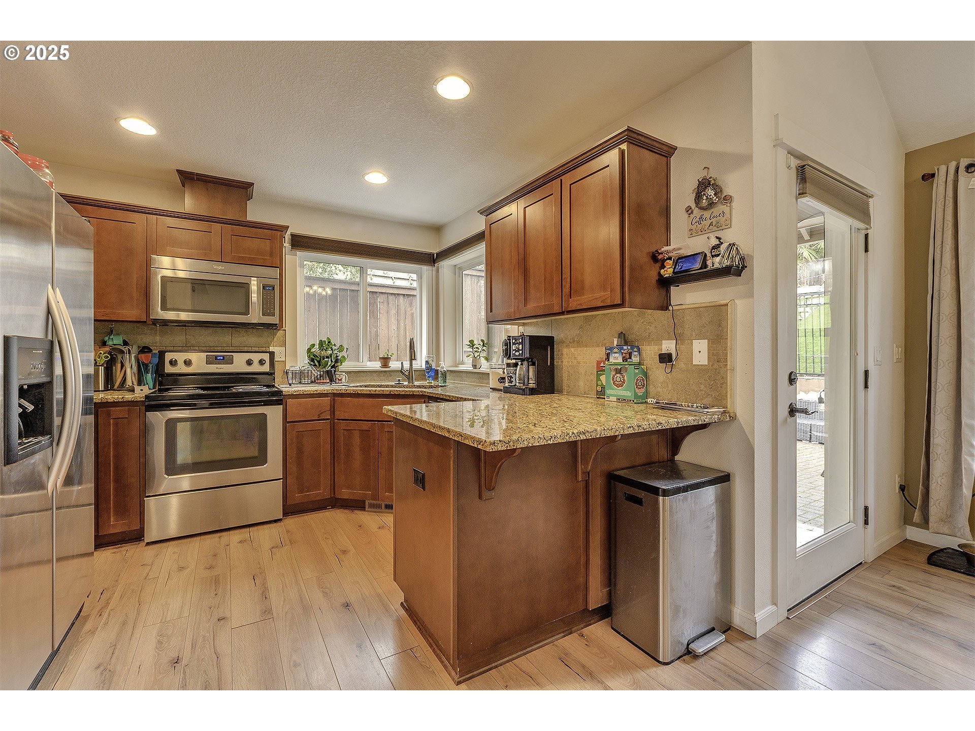 35505 Iris Way St. Helens, OR 97051 - Photo 3 of 17 a kitchen with granite countertop a refrigerator stove and microwave