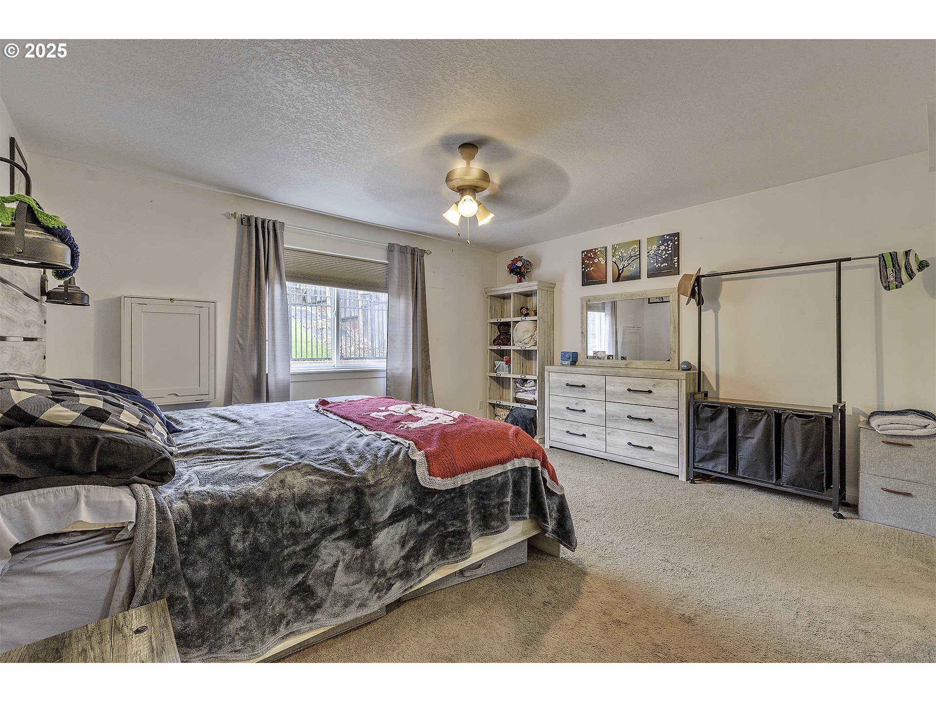 35505 Iris Way St. Helens, OR 97051 - Photo 7 of 17 a bedroom with a bed a dresser and a chandelier