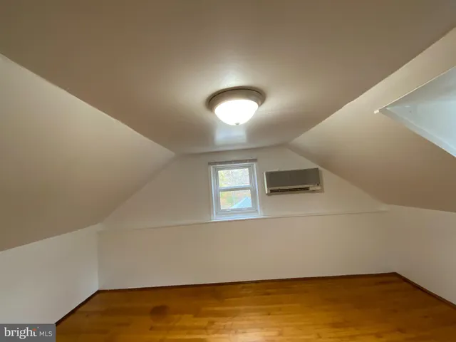 a view of a room with wooden floor and window