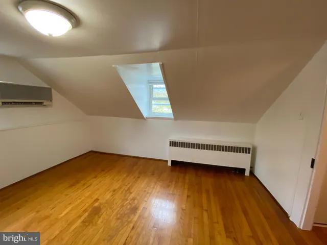 a view of a room with wooden floor and window