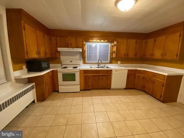 a kitchen with stainless steel appliances a stove sink and cabinets