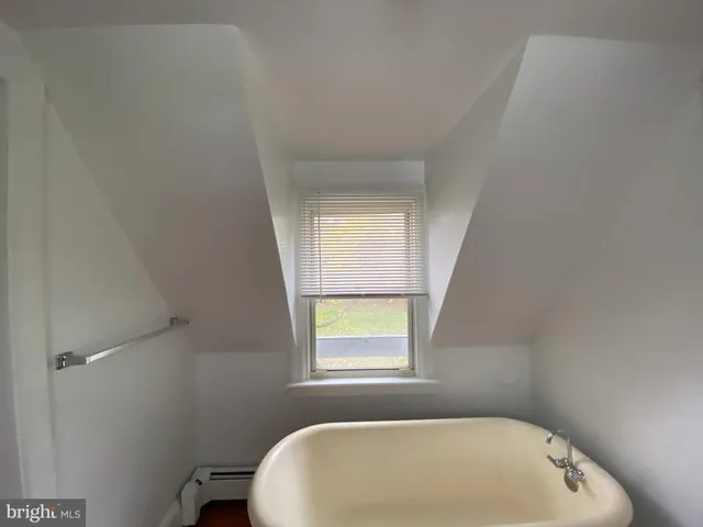 a bathroom with a bathtub and window