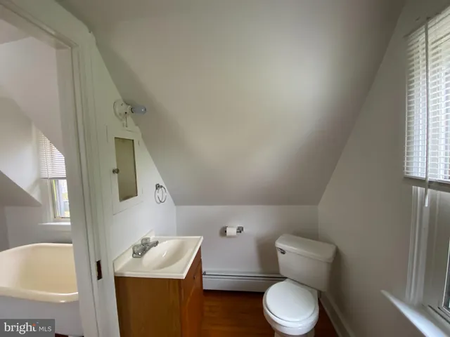 a white toilet sitting next to a bathroom sink
