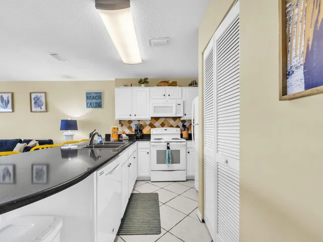 a kitchen with stainless steel appliances granite countertop a sink and cabinets