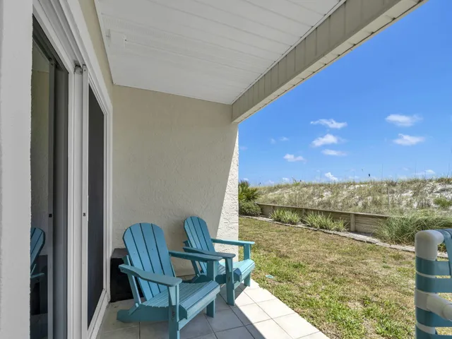 a view of a balcony with chairs and a table