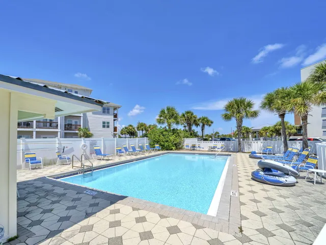 a view of a house with swimming pool and sitting area