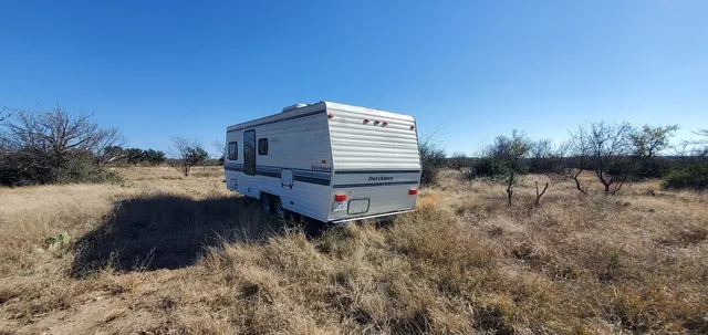 a kitchen with stainless steel appliances wooden cabinets a refrigerator and a table