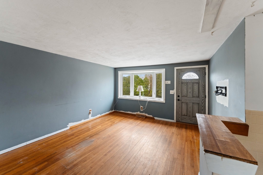 38 Orton Street Worcester, MA 01604 - Photo 4 of 37 an empty room with wooden floor and windows