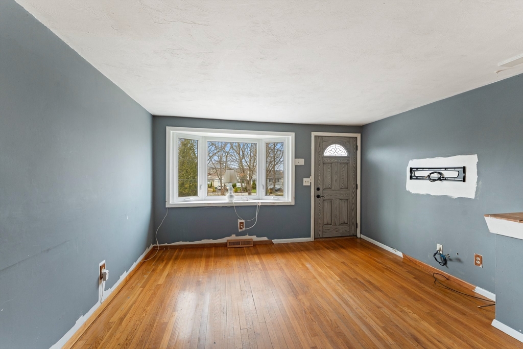 38 Orton Street Worcester, MA 01604 - Photo 5 of 37 an empty room with wooden floor and windows