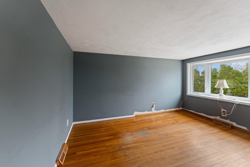 38 Orton Street Worcester, MA 01604 - Photo 6 of 37 a bedroom with a bed and a window