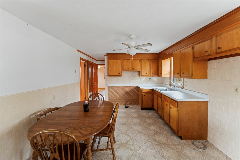 38 Orton Street Worcester, MA 01604 - Photo 8 of 37 a kitchen with granite countertop a sink a stove and chairs