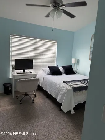 a bedroom with a bed and a television
