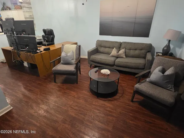 a living room with furniture and a lamp