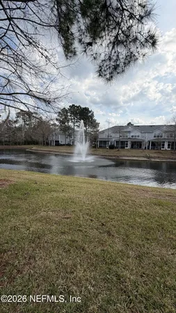 a view of a lake with houses in the back