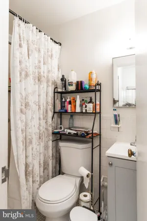 a bathroom with a sink mirror and shower
