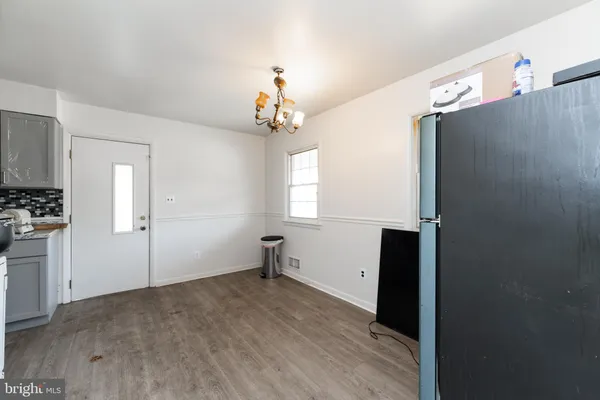 a kitchen with a refrigerator a stove top oven a sink and cabinets