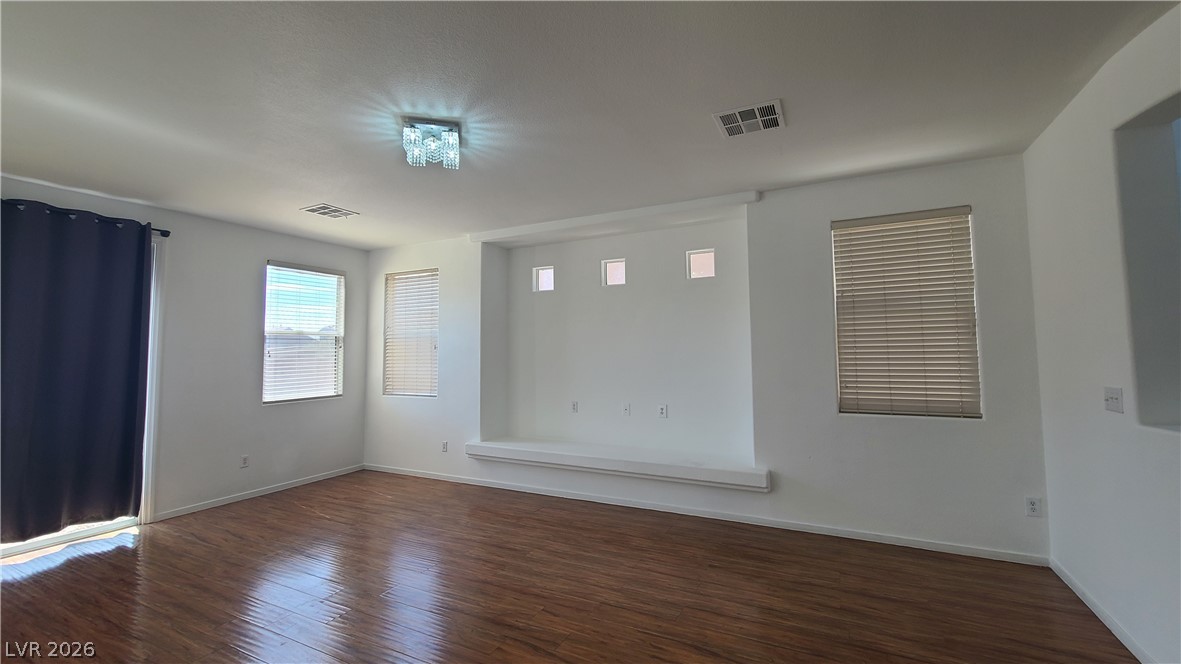 8944 Rutherford Grove Street Las Vegas, NV 89148 - Photo 5 of 35 Wood flooring and natural light elevate this versatile living space.