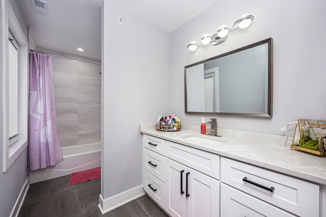a bathroom with a sink vanity and mirror