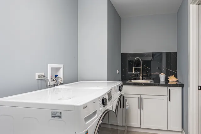 a kitchen with a sink a stove and cabinets