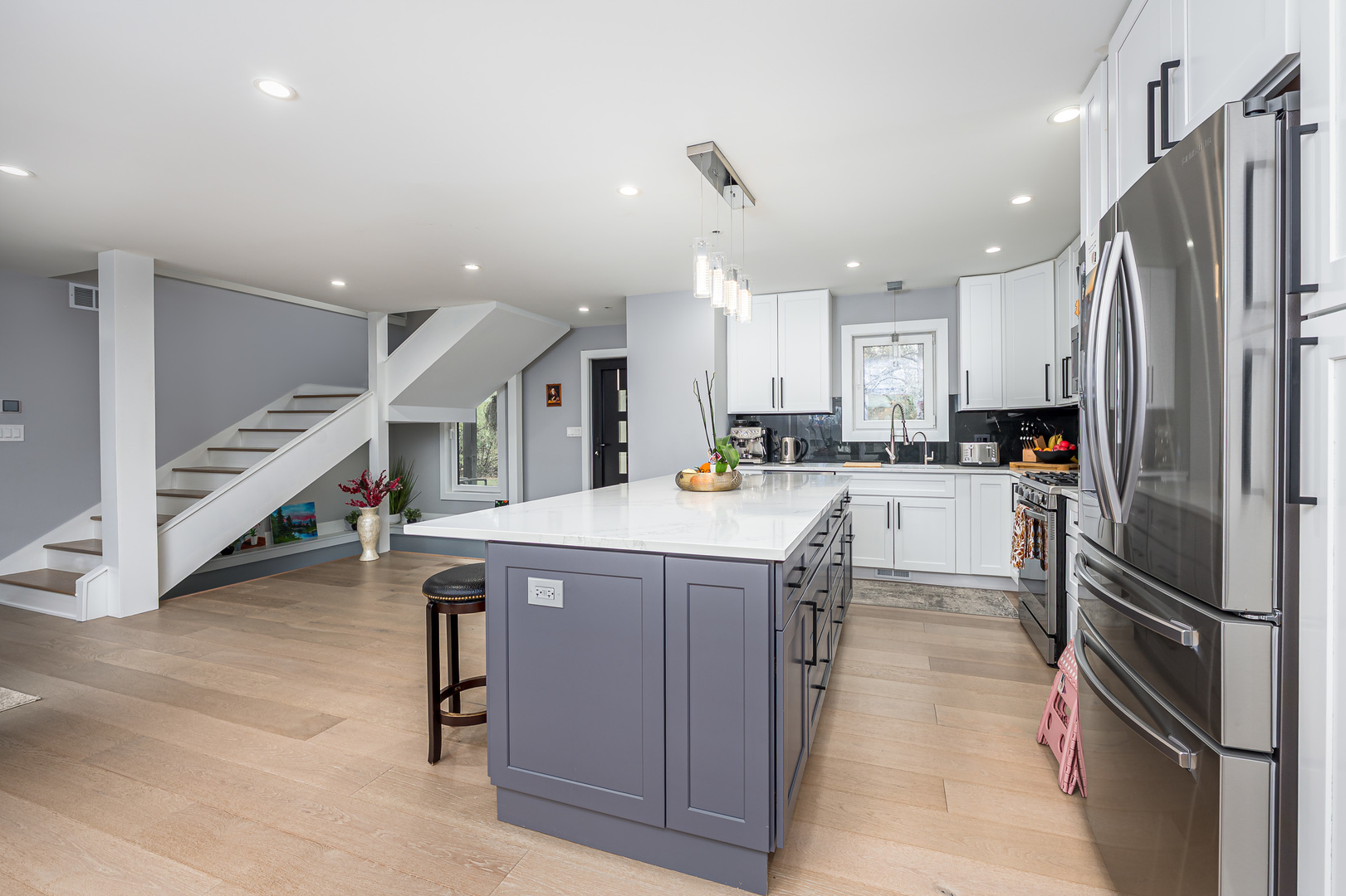 101 North Schoenbeck Road Prospect Heights, IL 60070 - Photo 5 of 30 a kitchen with stainless steel appliances kitchen island granite countertop a refrigerator a stove and a sink with wooden floor