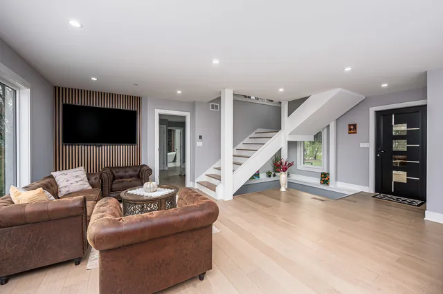 a living room with furniture and stairs