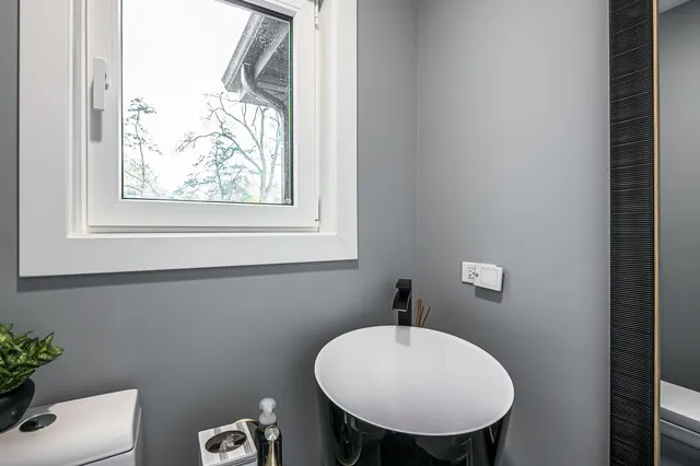 a bathroom with a toilet a sink and a mirror
