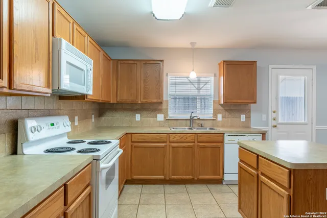 a kitchen with a sink stove and cabinets