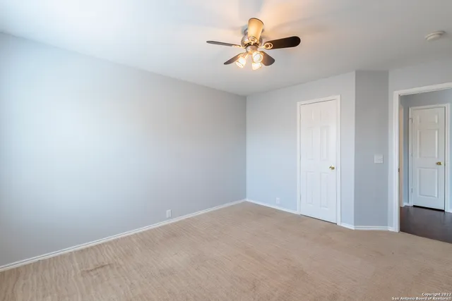 a view of a big room with a ceiling fan