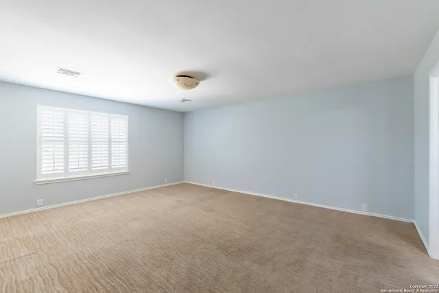 an empty room with a empty space and windows