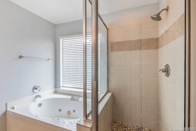 a bathroom with a tub and a shower