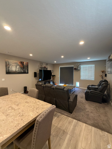118 Tram Rock Rd. Lake Point, UT 84074 - Photo 13 of 34 Open-concept living space featuring recessed lighting, a neutral color palette, wood-finish flooring, and a window with horizontal blinds