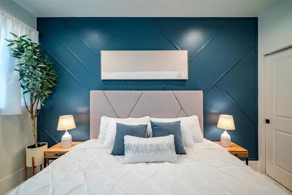 a bedroom with a bed and a lamp