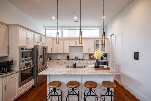 a kitchen with stainless steel appliances and wooden cabinets