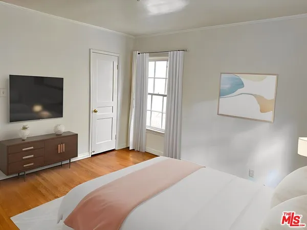 a bedroom with a bed and flat screen tv