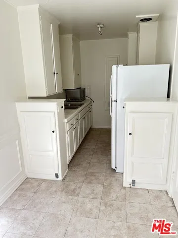 a kitchen with a cabinets and a stove top oven