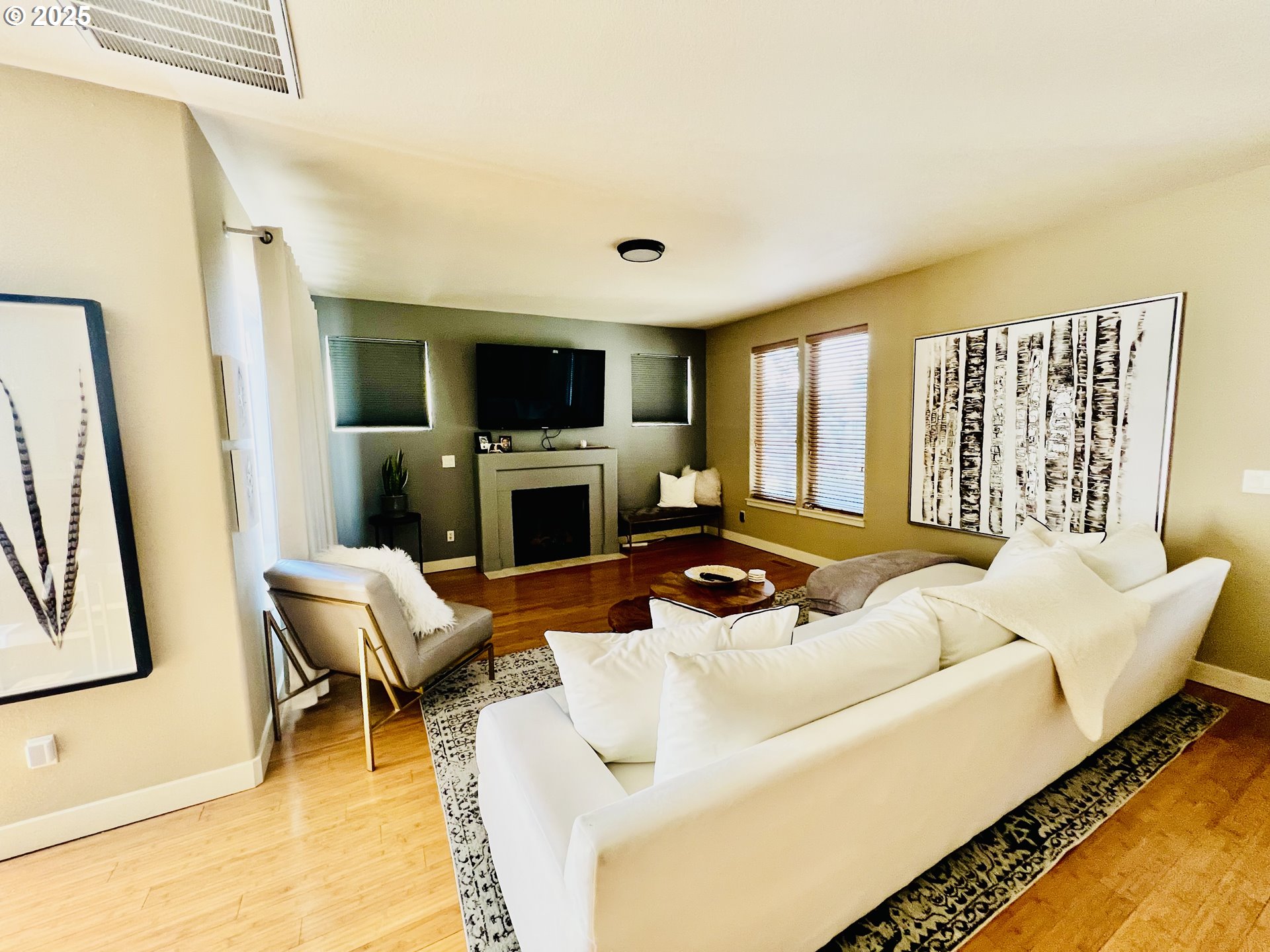 61257 Bronze Meadow Lane Bend, OR 97702 - Photo 3 of 16 a living room with furniture a fireplace and a flat screen tv