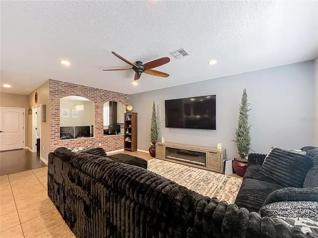 a bedroom with a bed a flat screen tv and a couch