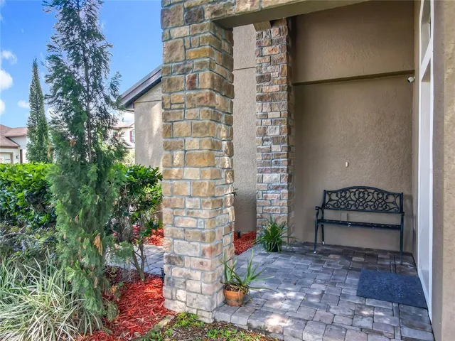 a front view of a house with a plants and trees