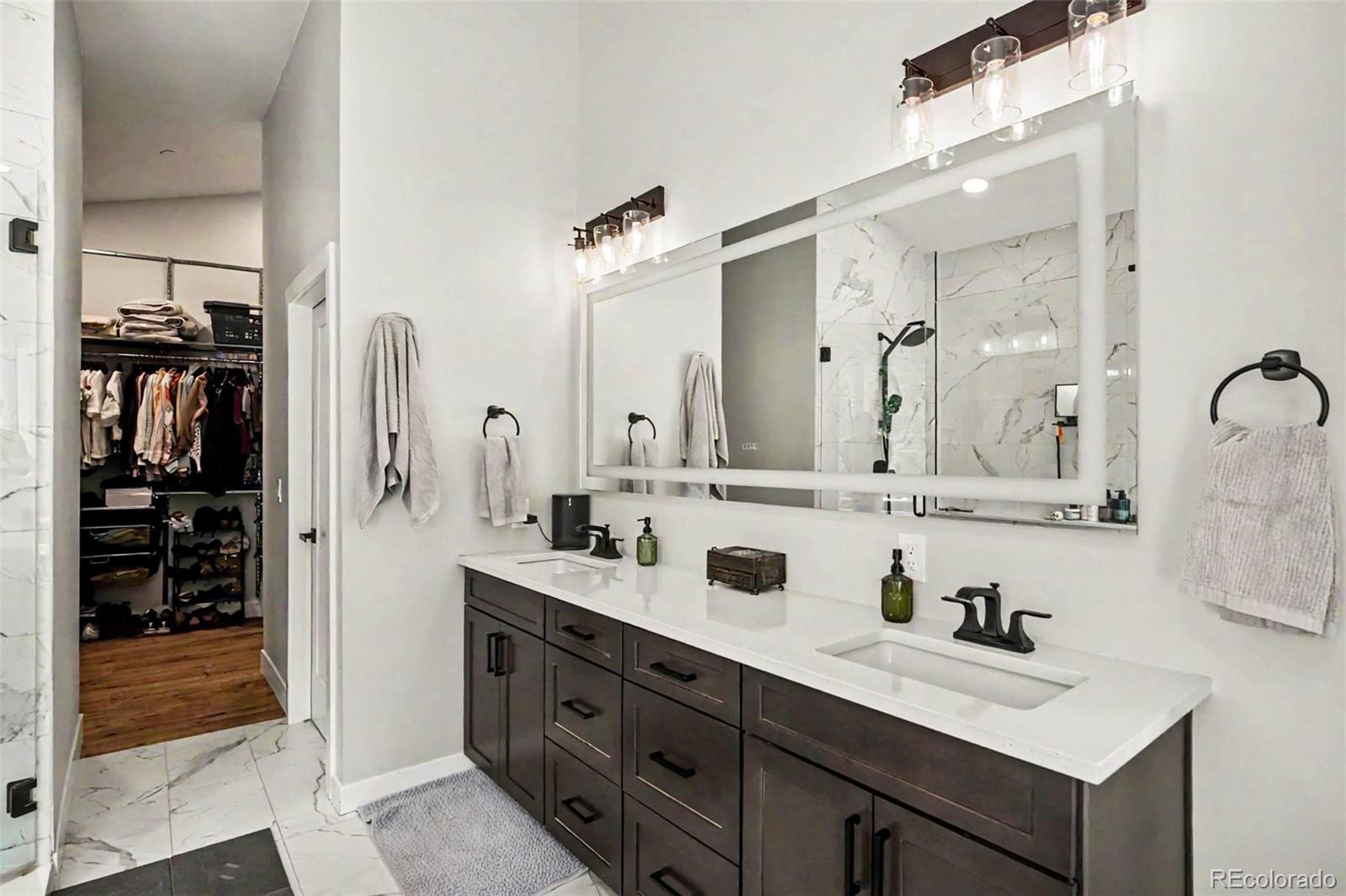 7231 Timber Trail Road Evergreen, CO 80439 - Photo 17 of 35 a bathroom with a sink double vanity and shower